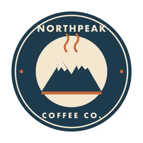 Round navy coffee shop badge logo with a cream mountain, rust-colored steam lines and the words Northpeak Coffee Co.